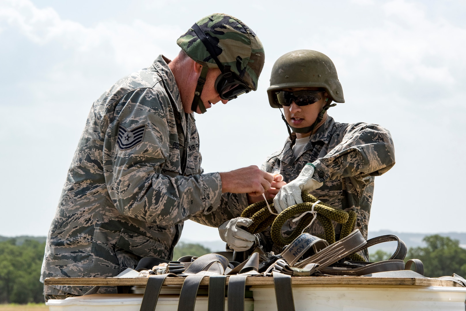 Airmen from the 26th Aerial Port Squadron rig an A-22 cargo bag with 2,000 pounds of “relief supplies” in preparation for a sling load mission as part of Operation Lone Star Vigilance June 10, 2018, at Joint Base San Antonio-Camp Bullis, Texas. Operation Lone Star Vigilance was a joint-training exercise involving Active-Duty and Reserve Airmen and Soldiers from the Texas Army National Guard from installations across San Antonio. The multi-service missions saw the successful completion of aerial reconnaissance, sling loading of cargo, MEDEVAC hoists, personnel recovery and the simultaneous operation of multiple helicopter landing zones. (U.S. Air Force photo by Senior Airman Stormy Archer)