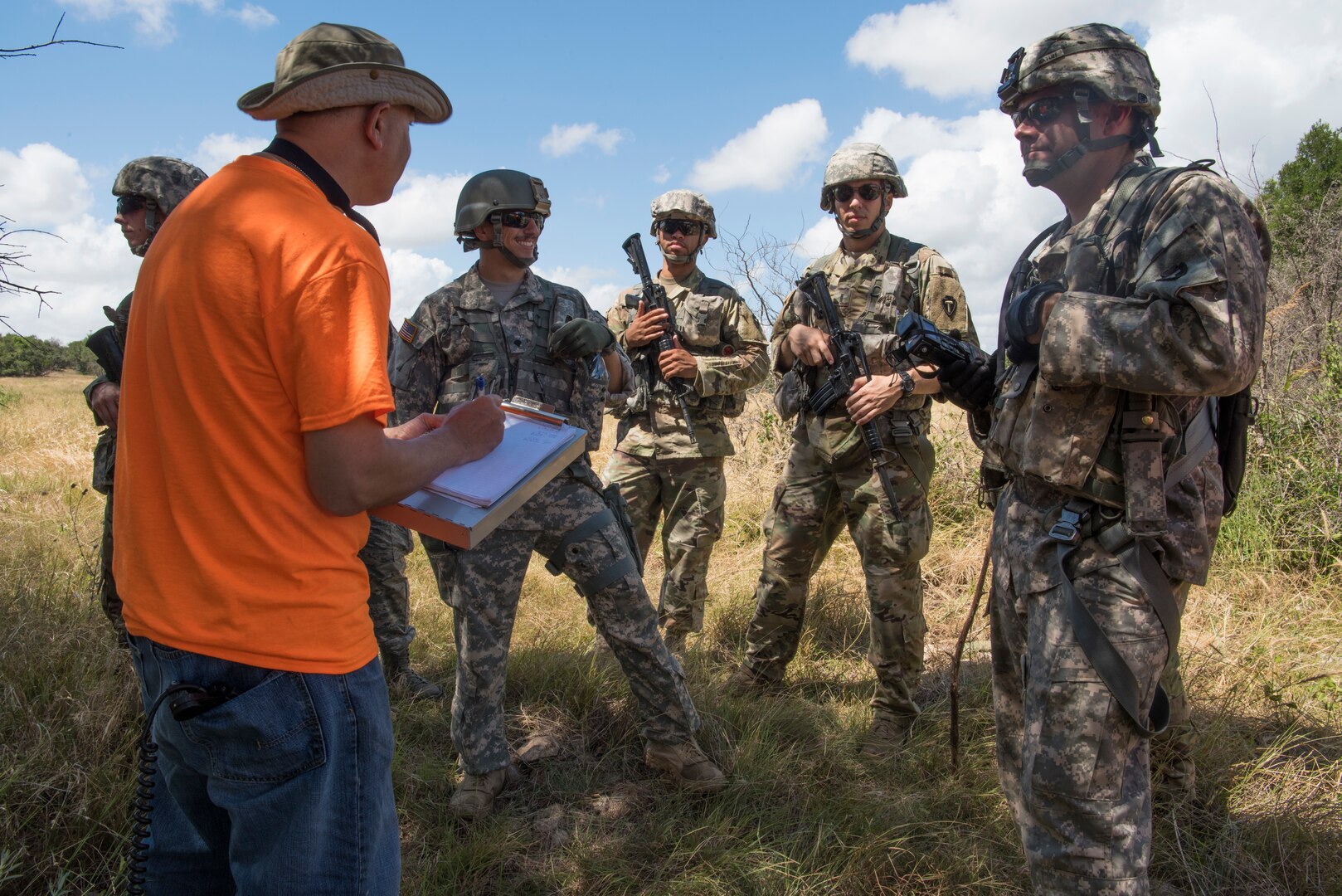 Soldiers from Texas Army National Guard Company C, 2-149 Aviation speak to Col. Kjäll Gopaul, mission pathfinder and Air Force Personnel Operations Agency deputy director, June 15, 2018, during a personnel recovery mission during Operation Lone Star Vigilance at Joint Base San Antonio-Camp Bullis, Texas. Soldiers were required to negotiate with military members role playing as friendly foreign nationals in order to call in an evacuation. (U.S. Air Force photo by Airman Shelby Pruitt)