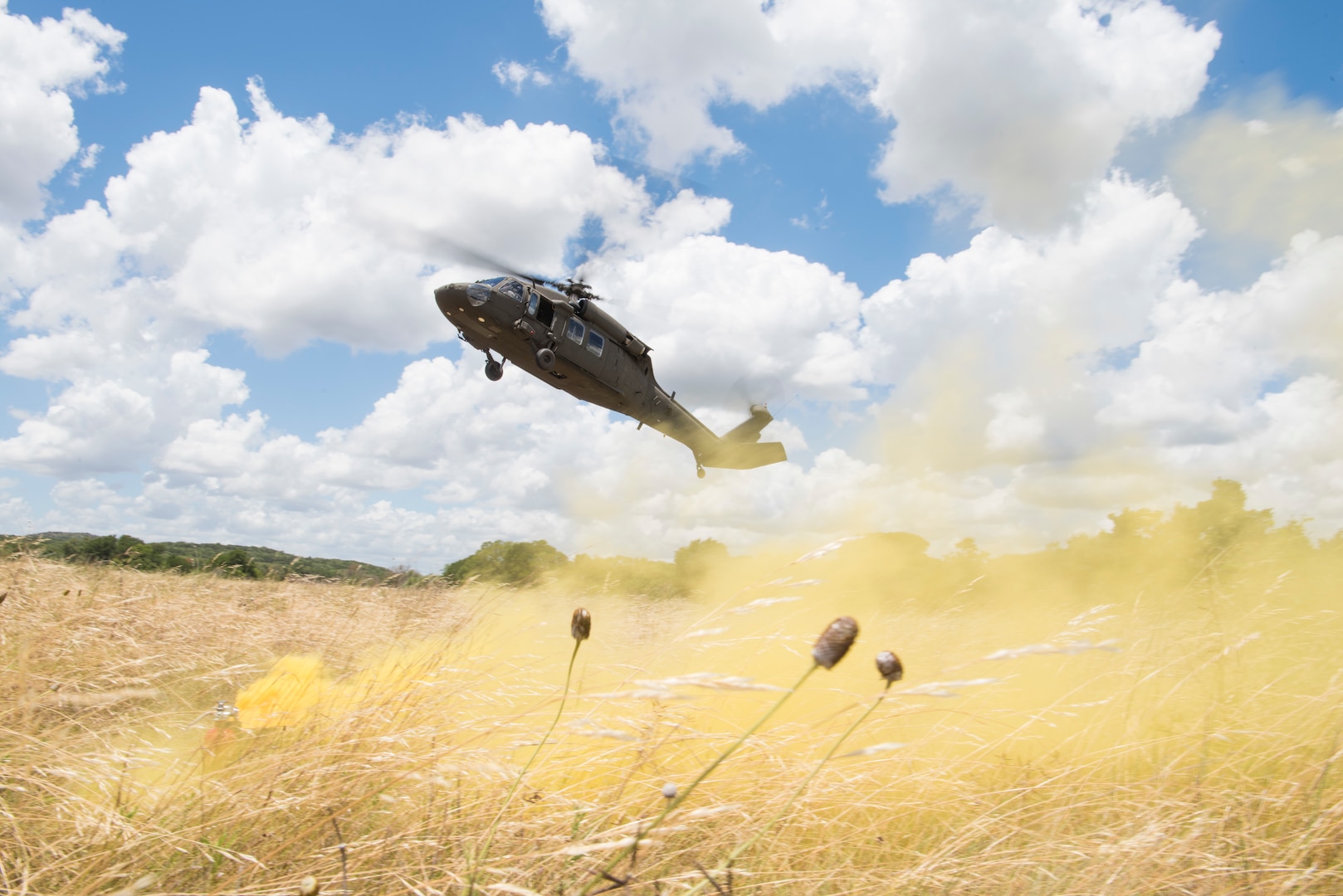 A UH-60 Black Hawk helicopter flown by members of Texas Army National Guard Company C, 2-149 Aviation lifts off after the completion of a personnel recovery mission during Operation Lone Star Vigilance June 15, 2018, at Joint Base San Antonio-Camp Bullis, Texas. Operation Lone Star Vigilance was a joint-training exercise involving Active-Duty and Reserve Airmen and Soldiers from the Texas Army National Guard from installations across San Antonio. The multi-service missions saw the successful completion of aerial reconnaissance, sling loading of cargo, MEDEVAC hoists, personnel recovery and the simultaneous operation of multiple helicopter landing zones. (U.S. Air Force photo by Airman Shelby Pruitt)