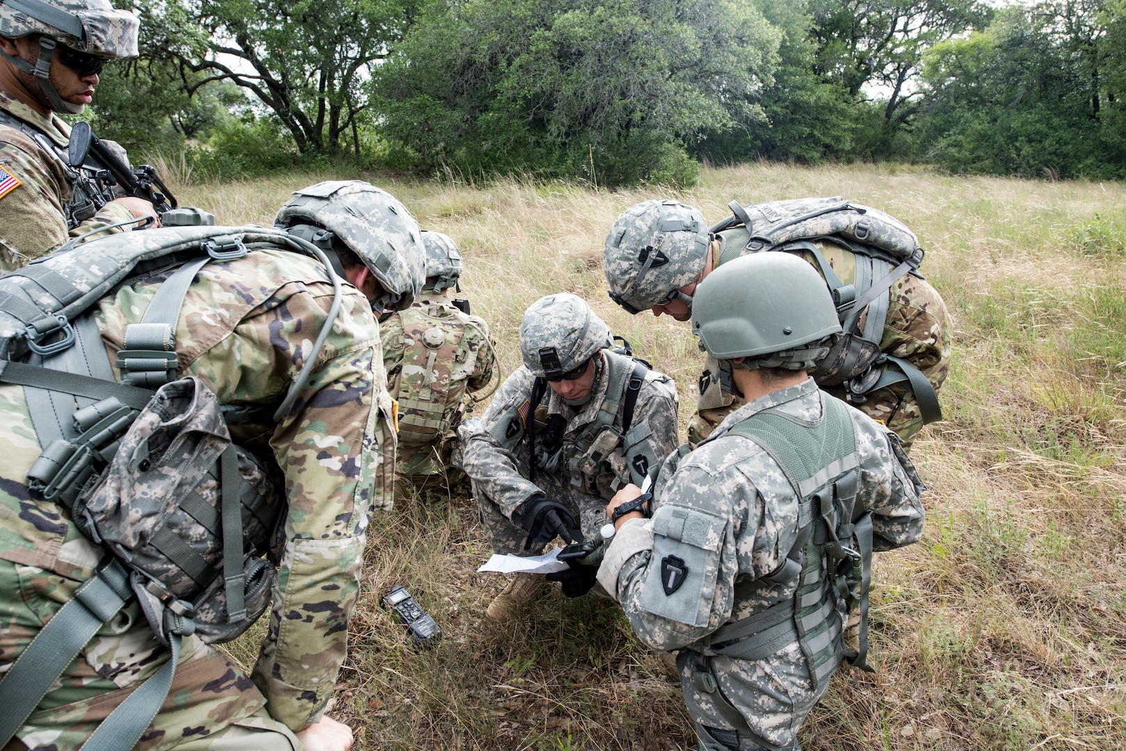 Army Capt. Robert Ratliff, Texas Army National Guard Company C, 2-149 Aviation platoon leader, uses a map to lead a downed aircrew to their extraction point as part of a personnel recovery mission during Operation Lone Star Vigilance, a joint, total force exercise, June 15, 2018, at Joint Base San Antonio-Camp Bullis, Texas. Operation Lone Star Vigilance was a joint-training exercise involving Active-Duty and Reserve Airmen and Soldiers from the Texas Army National Guard from installations across San Antonio. The multi-service missions saw the successful completion of aerial reconnaissance, sling loading of cargo, MEDEVAC hoists, personnel recovery and the simultaneous operation of multiple helicopter landing zones. (U.S. Air Force photo by Senior Airman Stormy Archer)