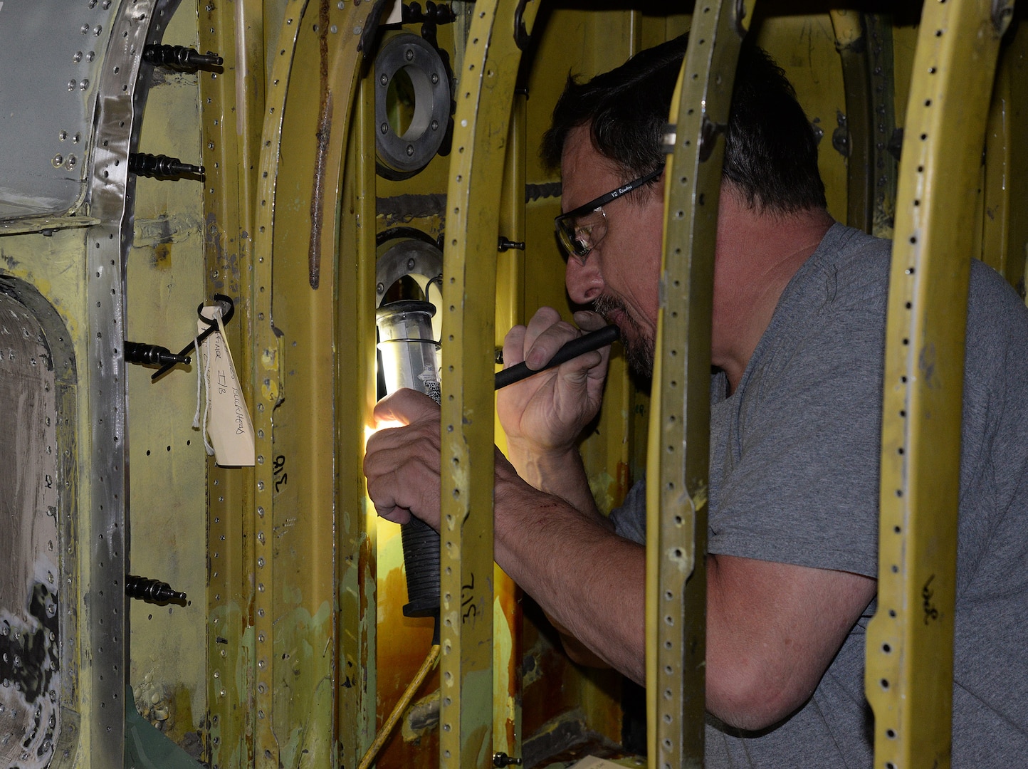 Lloyd Fellbaum, 575 AMXS Sheetmetal Technician, works inside the confined space of what is normally the forward fuel bladder on a T-38 Talon.