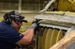 Michael Ramirez, 575th AMXS Sheet Metal Technician, checks the alignment on a new left hand upper center longeron being installed on a T-38 Talon during the PCIII modification package.