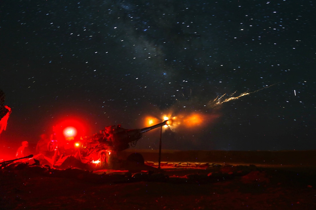 U.S. soldiers and Iraqi forces fire a howitzer at Islamic State of Iraq and Syria positions near the Iraqi-Syrian border during Operation Roundup.