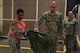 Senior Airman Shalice Chambers, a 319th Logistics Readiness Squadron equipment journeyman, assists in a readiness exercise June 14, 2018, on Grand Forks Air Force Base, North Dakota. Chambers ensured all Airmen had the proper deployment bad for the exercise. (U.S. Air Force photo by Airman 1st Class Melody K. Wolff)