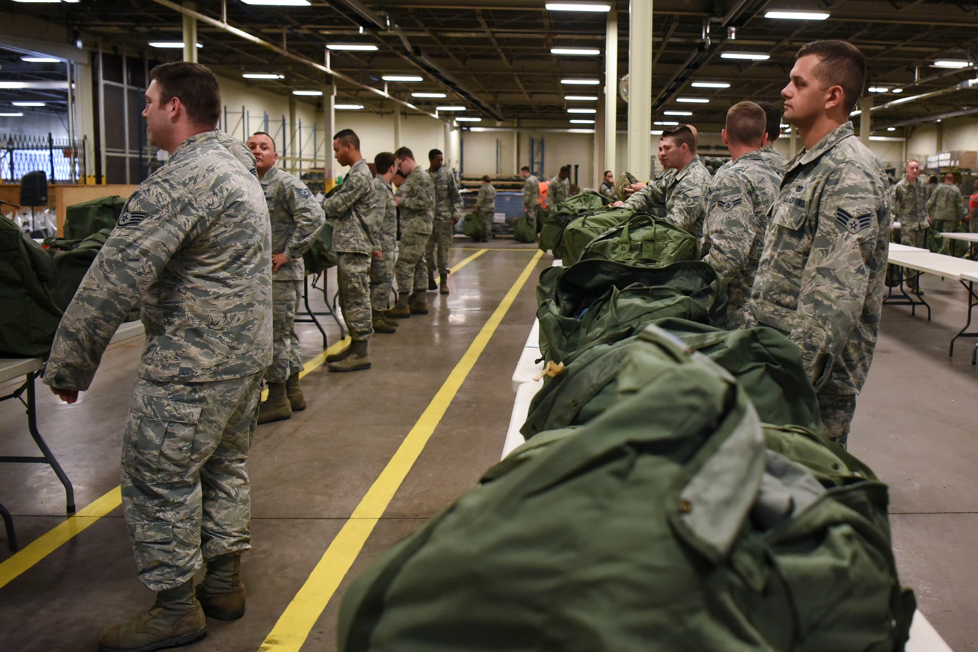 Airmen prepare for a readiness exercise June 14, 2018, on Grand Forks Air Force Base, North Dakota. In this preparation step, Airmen were instructed to ensure they had the proper equipment in their bags for the exercise. (U.S. Air Force photo by Airman 1st Class Melody K. Wolff)