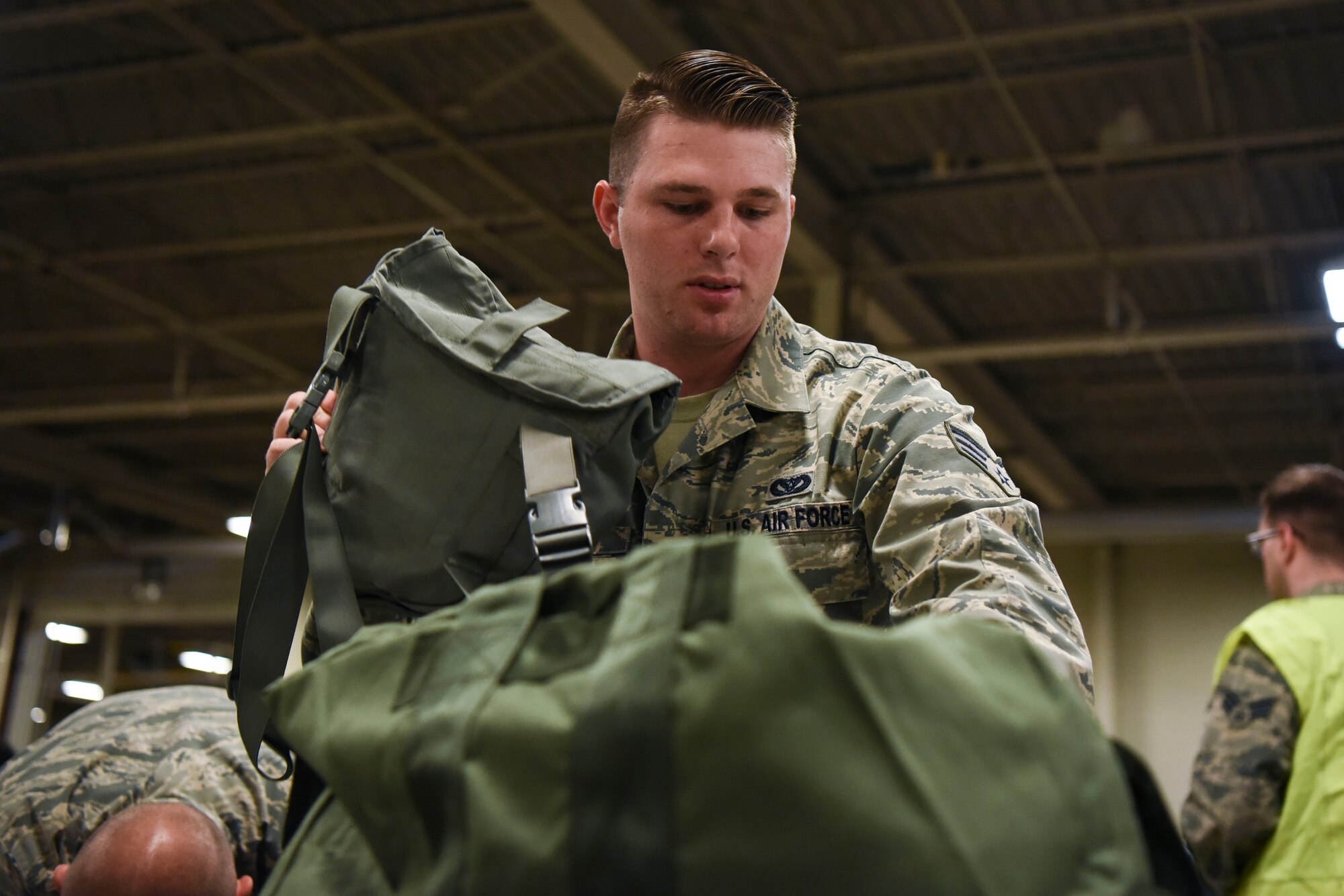 Senior Airman Patrick Archer, a 319th Civil Engineer Squadron pest management journeyman, prepares his bag for a readiness exercise June 14, 2018, on Grand Forks Air Force Base, North Dakota. Archer, along with other Airmen, were given a check list of the necessary items to be fully prepared for the exercise. (U.S. Air Force photo by Airman 1st Class Melody K. Wolff)