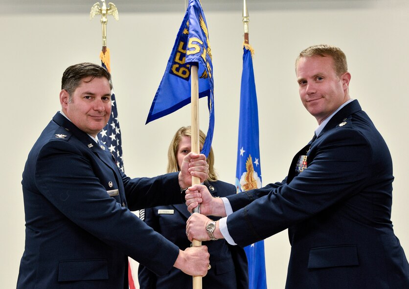 Lt. Col. Daniel Dunn, right, assumes command of the 512th Cyber Intelligence Squadron, 655th Intelligence, Surveillance and Reconnaissance Group, during a change of command ceremony June 10, 2018.