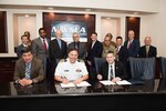 Naval Surface Warfare Center, Carderock Division Commanding Officer Capt. Mark Vandroff (center) and Technical Director (acting) Dr. Paul Shang (left) sign an Education Partnership Agreement with Dr. J. Scott Cameron (right) president of the National Intelligence University, in West Bethesda, Md., June 11, 2018. (Seated from left) Shang, Vandroff and Cameron. (Standing from left) Carderock Marine and Aviation Division Head Steve Ebner (Code 88), Carderock Patent Attorney Dave Ghatt, Carderock Director of Strategic Relations Dr. John Barkyoumb, NIU Professor Dr. Peter Leitner, NIU Dean of the School of Science and Technology Intelligence Dr. Brian Holmes, NIU faculty member MSG Angel Morales, Carderock Electrical Engineer Dr. Peter Cho (Code 88), Department Head Naval Architecture and Engineering Mike Brown and Carderock Director of Technology Transfer Dr. Joseph Teter (Code 00T). (U.S. Navy photo by Nicholas Brezzell/Released)