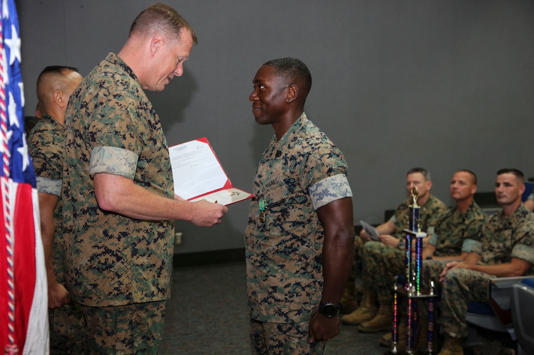 Maj. Gen. Mark R. Wise, commanding general of 3rd Marine Aircraft Wing, presents a Navy and Marine Corps Achievement Medal to Staff Sgt. Lawrence D. Wilson, a career planner for Marine Fighter Attack Squadron (VMFA) 314, Marine Air Group (MAG) 11, for his efforts as the fiscal year 2017 3rd MAW career planner of the year, during the 3rd MAW Annual Retention Awards Ceremony at Marine Corps Air Station Miramar, Calif., June 15. The award ceremony was held to reinforce the importance of enlisted retention throughout 3rd MAW and to recognize superior performance of career planners and the units during the 2017 retention campaign. (U.S. Marine Corps photo by Cpl. Joshua S. McAlpine/ Released)