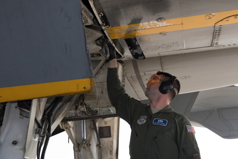 Staff Sgt. Nicholas Kinzer, 660th Aircraft Maintenance Squadron KC-10 Extender assistant flying crew chief, cleans up hydraulic fluid under a KC-10 at Misawa Air Base, Japan, June 4, 2018. Kinzer helped fix a leak so the aircraft could support a refueling mission in the Pacific theater. Flying crew chiefs are responsible for maintaining aircraft during missions away from that aircraft’s home station. (U.S. Air Force photo by Tech. Sgt. James Hodgman)