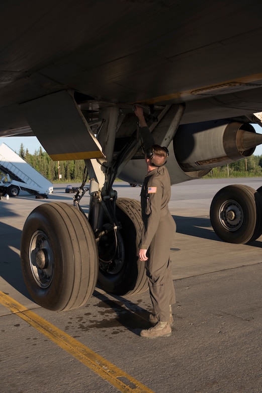 Staff Sgt. Scott Sanders, 660th Aircraft Maintenance Squadron KC-10 Extender flying crew chief, performs an external check of a KC-10 during pre-flight prep before leaving Eielson Air Force Base, Alaska, June 6, 2018. Sanders served as one of two crew chiefs on the KC-10 for a five-day refueling mission in the Pacific theater. Flying crew chiefs are responsible for maintaining aircraft during missions away from that aircraft’s home station. (U.S. Air Force photo by Tech. Sgt. James Hodgman)