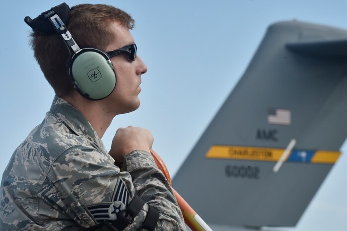Staff Sgt. James Crance, 437th Aircraft Maintenance Squadron crew chief, listens to aircrew members over a headset during a pre-launch inspection of a C-17 Globemaster III June 14, 2018, at Joint Base Charleston, S.C. Crew chiefs here are responsible for coordinating the care and maintenance of one of the largest fleets of C-17 aircraft in the Air Force in support of Air Mobility Command’s rapid global mobility mission. (U.S. Air Force photo by Staff Sgt. Christopher Hubenthal)