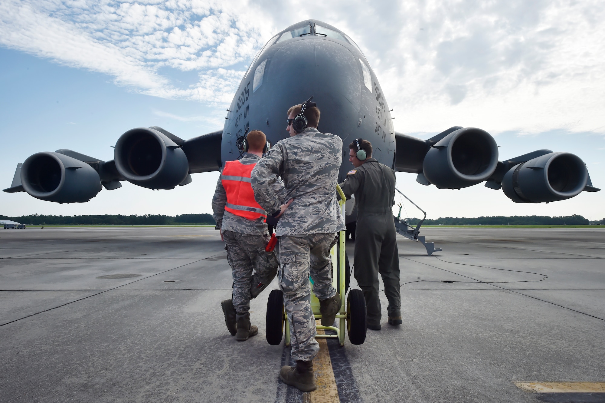 Airman 1st Class Andrew Causey, left, and Staff Sgt. James Crance, center, both 437th Aircraft Maintenance Squadron crew chiefs, work with the aircrew of a C-17 Globemaster III prior to launch June 14, 2018, at Joint Base Charleston, S.C. Crew chiefs here are responsible for coordinating the care and maintenance of one of the largest fleets of C-17 aircraft in the Air Force in support of Air Mobility Command’s rapid global mobility mission.