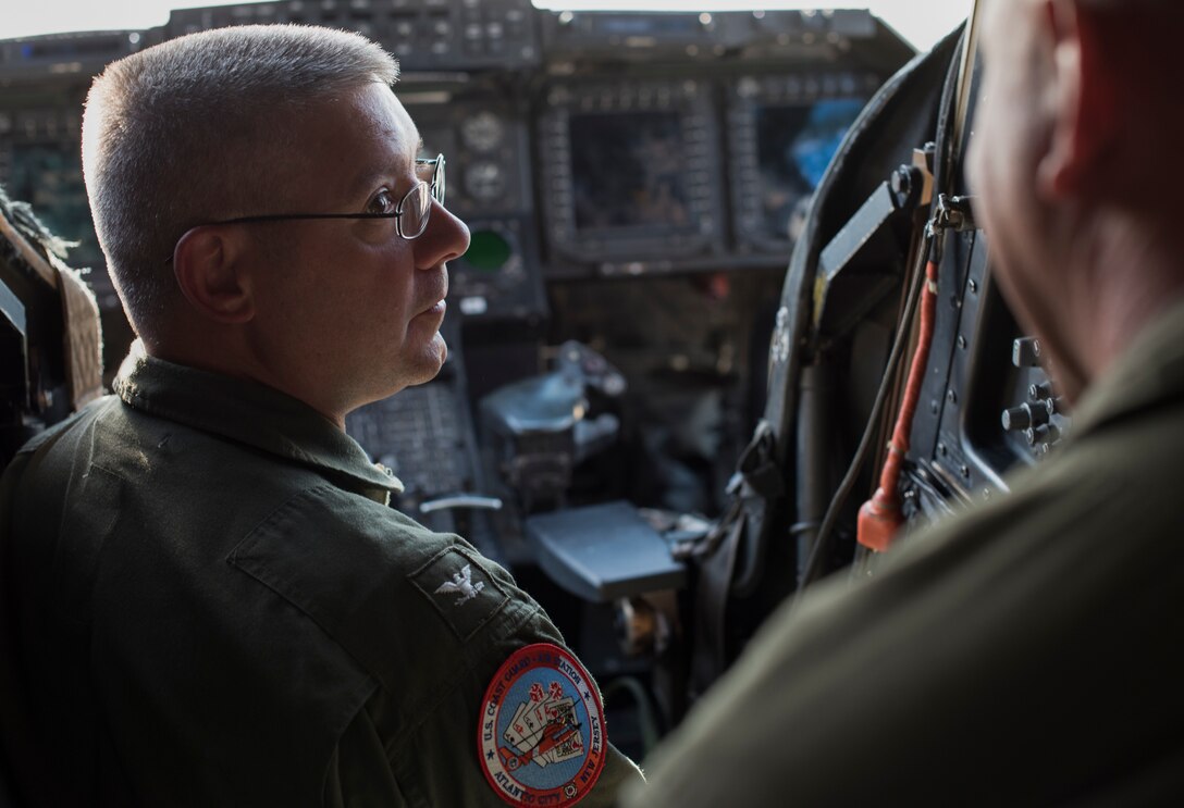 U.S. Coast Guard Capt. Eric Gleason, Coast Guard Air Station Atlantic City commanding officer, listens to U.S. Marine Corps Lt. Col. Eric Burns, Marine Medium Tilt Roader Squadron (VMM) 774 commanding officer on Coast Guard Air Station Atlantic City, N.J., June 14, 2018. Burns explained to Gleason how the Marines prepared for the first forward air-refueling point between a Marine V-22 Osprey and a Coast Guard HH-65 Dolphin. (U.S. Air Force photo by Airman Ariel Owings)