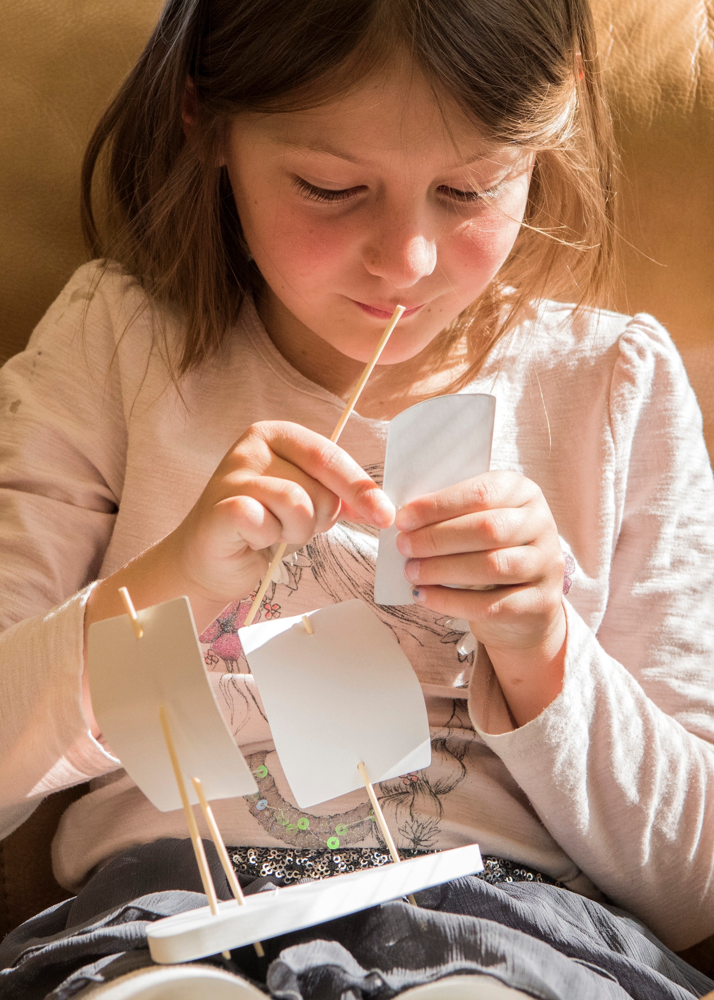 Reese, 7, assembles a take-home craft at the Joint Base Elmendorf-Richardson Library, June 13, 2018. The Summer Reading Program “Reading Takes You Everywhere,” includes bi-weekly cultural events where children can do crafts and observe presentations by different artists highlighting areas of the world. Other weeks, family game nights are scheduled and a take-home craft is available.