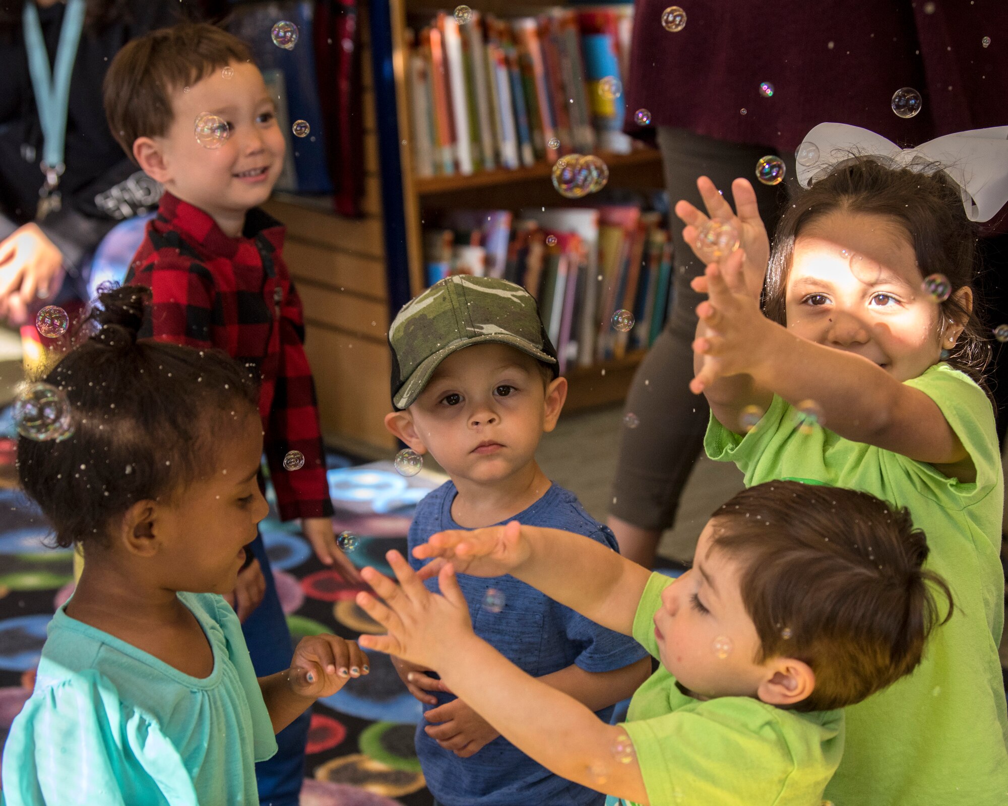 Children pop bubbles during a reading time at the Joint Base Elmendorf-Richardson Library, June 13, 2018. The library is hosting weekly events through July 2018 to coincide with this year’s Summer Reading Program “Reading Takes You Everywhere.” The program offers individuals the opportunity to collect prizes for time spent reading or being read to.