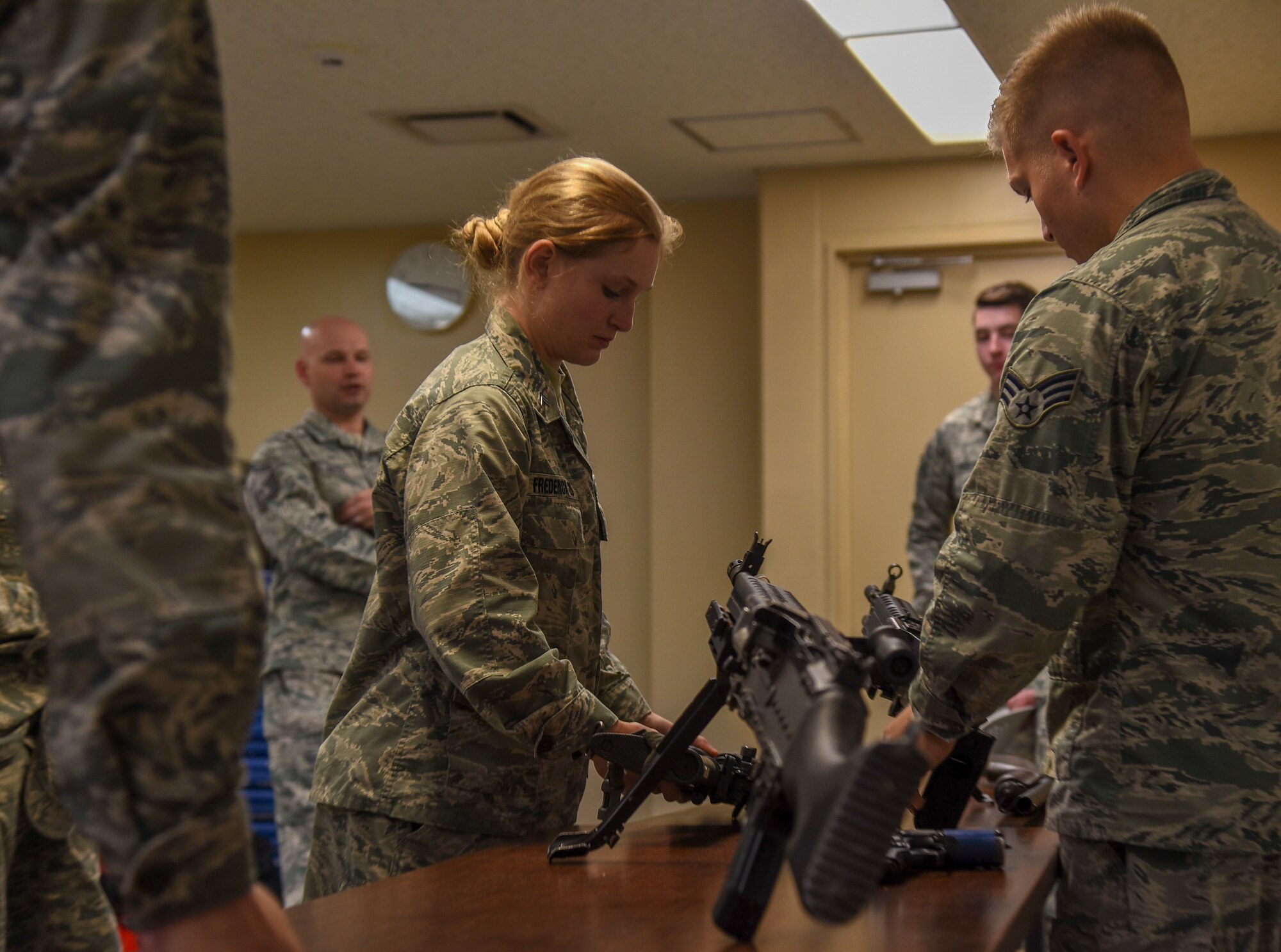 Cadet 2nd Class Jessica Frederick, a United States Air Force Academy cadet, examines a weapon on display during a security forces tour at Misawa Air Base, Japan, June 18, 2018. This demonstration was one of many the USAFA cadets had the opportunity to take part in during Operation Air Force, a two-week immersion into active duty Air Force life. (U.S. Air Force photo by Airman 1st Class Collette Brooks)