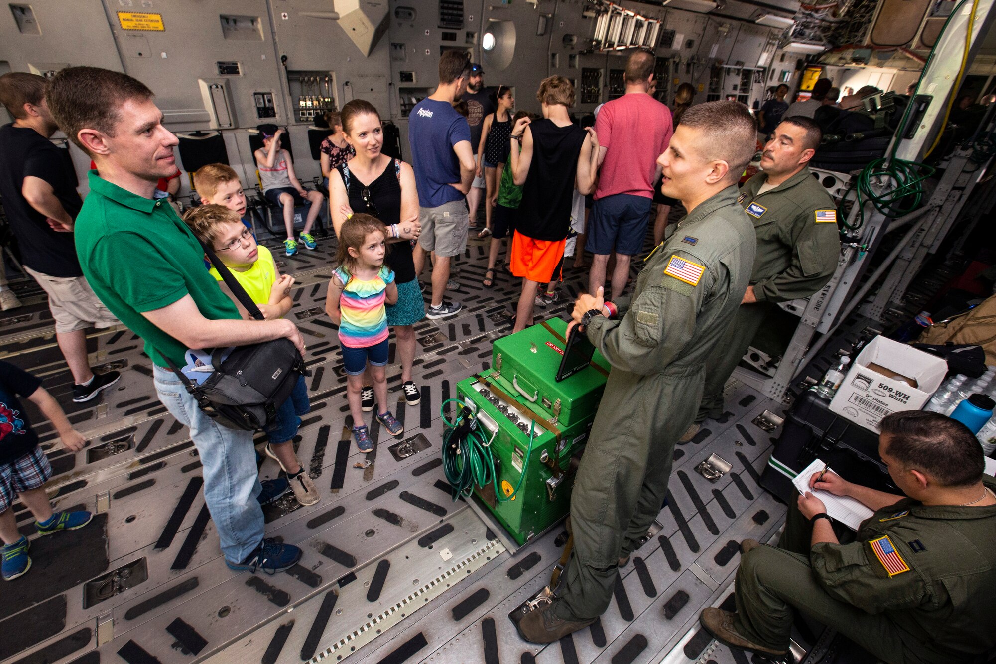U.S. Air Force 1st Lt. Jedd Dillman, green flight suit standing right, a flight nurse with the 514th Aeromedical Evacuation Squadron (AES), 514th Air Mobility Wing, answers visitors questions about the AES mission and the C-17 Globemaster III during the Innovations in Flight Family Day and Outdoor Aviation Display at the Steven F. Udvar-Hazy Center, Chantilly, Virginia, June 16, 2018. A KC-10 Extender and a C-17 crewed by Reserve Citizen Airmen with the 78th Air Refueling Squadron and the 732nd Airlift Squadron, both with the 514th Air Mobility Wing, participated in the event at the Center. The 514th is an Air Force Reserve Command unit located at Joint Base McGuire-Dix-Lakehurst, N.J. (U.S. Air Force photo by Master Sgt. Mark C. Olsen)