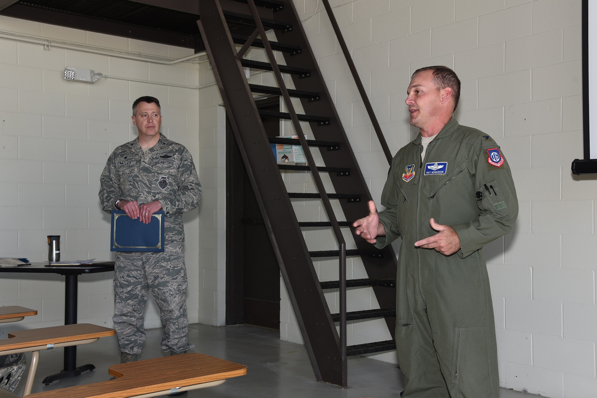 Col. Troy Henderson, the Air Combat Command (ACC) inspector general team chief, right, speaks to a group of 119th Logistics Readiness Squadron personnel as Col. Britt Hatley, the 119th Wing commander looks on during a unit effectiveness inspection (UEI) at the North Dakota Air National Guard Base, Fargo, N.D., May 20, 2018.