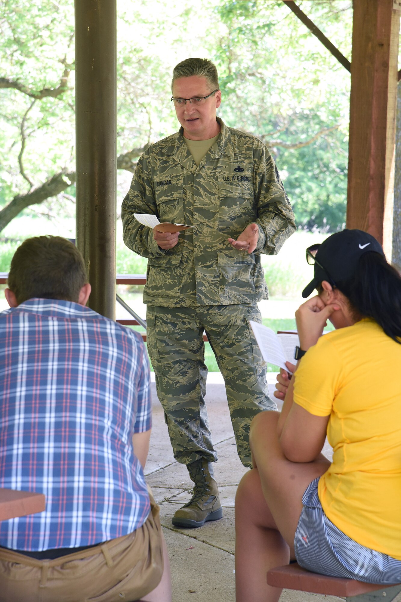 Chief Master Sgt. Duane Kangas, the 119th Wing command chief, standing, visits with members of the of the North Dakota Air National Guard junior enlisted advisory council (JEAC), during a leadership retreat at Fort Ransom State Park, near Fort Ransom, N.D., June 4, 2018.
