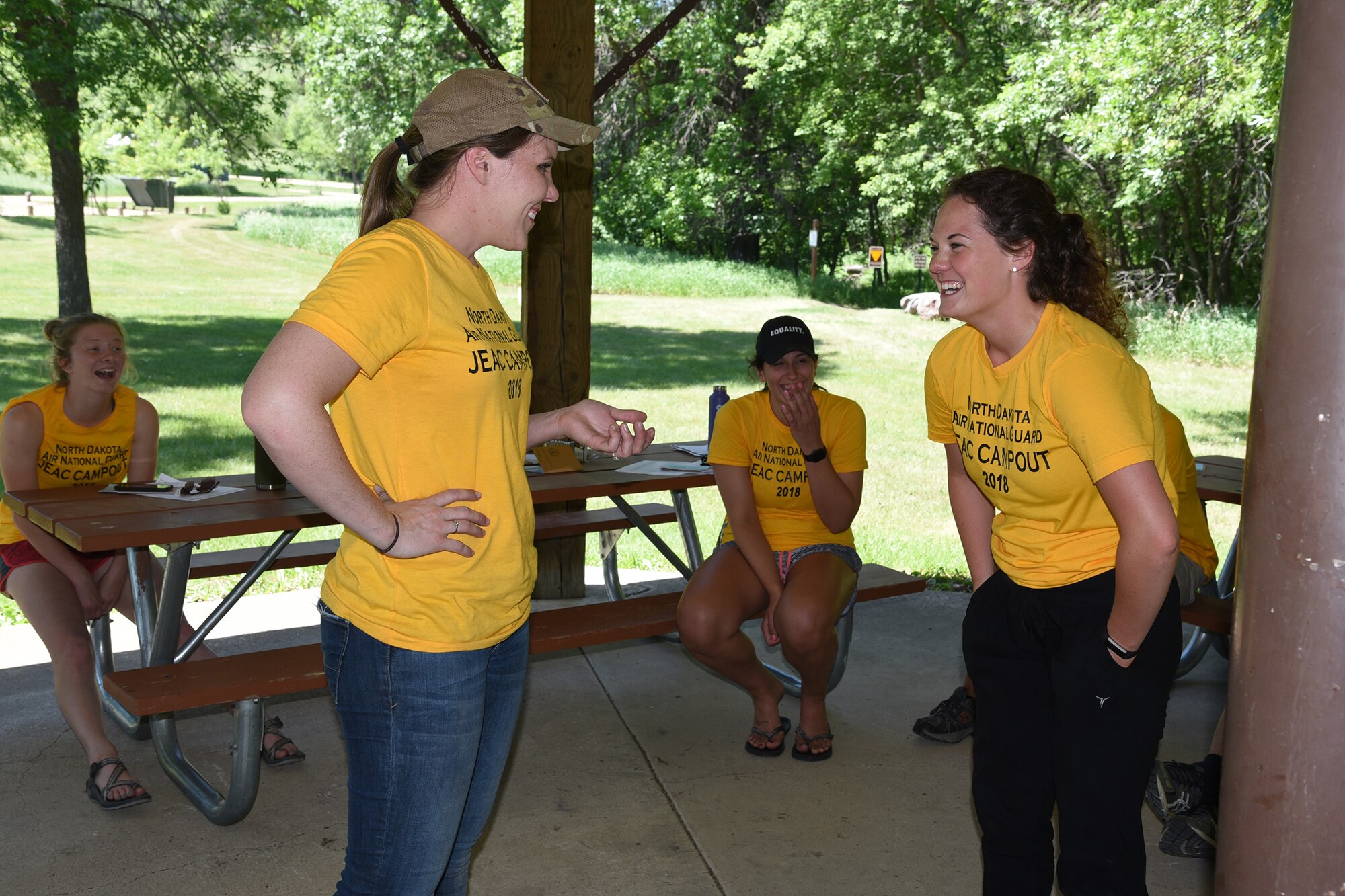 Tech. Sgt. Shelly Fink, foreground left, and Airman 1st Class Abby Swanson, foreground right, take roles in a conflict resolution scenario during a North Dakota Air National Guard junior enlisted advisory council (JEAC) leadership retreat at Fort Ransom State Park, near Fort Ransom, N.D., June 4, 2018.