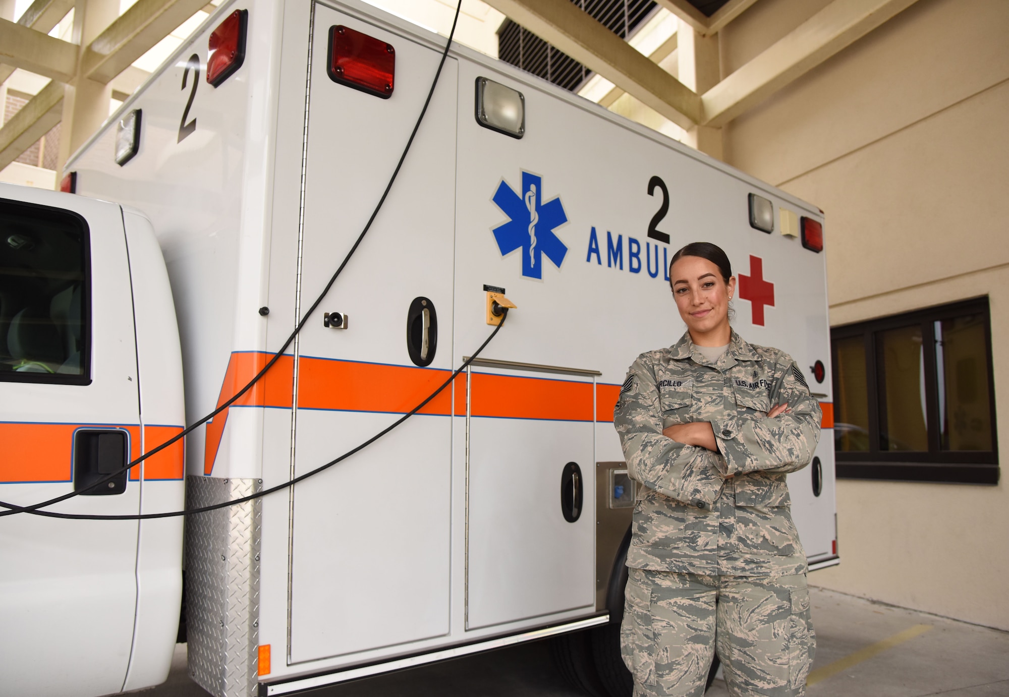 U.S. Air Force Tech. Sgt. Juliet Corcillo, 81st Medical Operations Squadron Emergency Department NCO in charge, poses for a photo in front of an ambulance outside of the Keesler Medical Center at Keesler Air Force Base, Mississippi, June 14, 2018. Corcillo was awarded a full ride scholarship to medical school from the Air Force’s Health Professions Scholarship Program. (U.S. Air Force photo by Kemberly Groue)