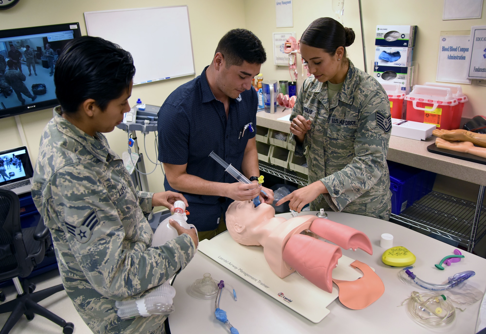 U.S. Air Force Tech. Sgt. Juliet Corcillo, 81st Medical Operations Squadron Emergency Department NCO in charge, conducts a respiratory training session with Senior Airman Lupita Lopez, 81st Aerospace Medicine Squadron medical technician, left, and Airman 1st Class Enrique Padron, 81st MDOS medical technician, in the Keesler Medical Center at Keesler Air Force Base, Mississippi, June 14, 2018. Corcillo was awarded a full ride scholarship to medical school and will begin her first day July 6 with a four-year scholarship from the Air Force’s Health Professions Scholarship Program. (U.S. Air Force photo by Kemberly Groue)