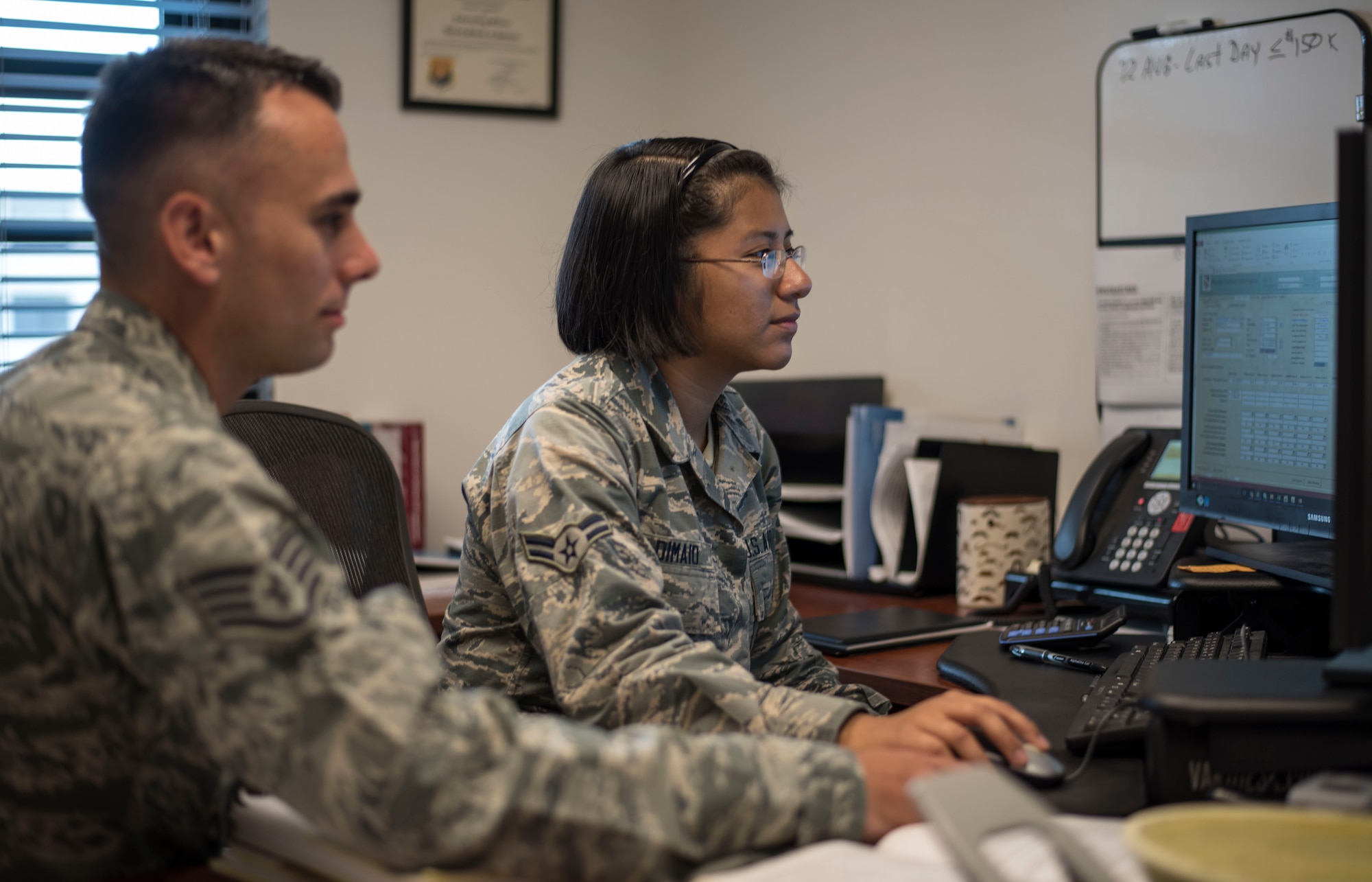 U.S. Air Force Staff Sgt. Blake Martin, a contracting supervisor and Airman 1st Class Gabrielle Dimaio, a contracting specialist, both assigned to the 6th Contracting Squadron (CONS), review a training plan for the new Contracting Information Technology (CON-IT) system at MacDill Air Force Base, Fla., June 20, 2018.