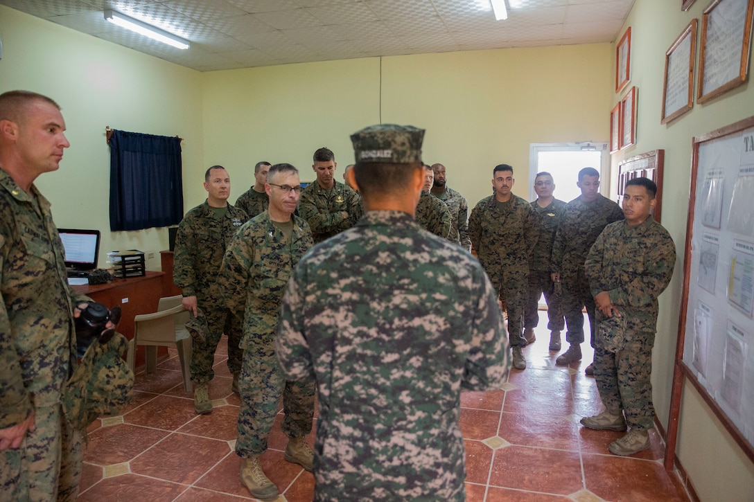 A group of military personnel conduct a briefing.