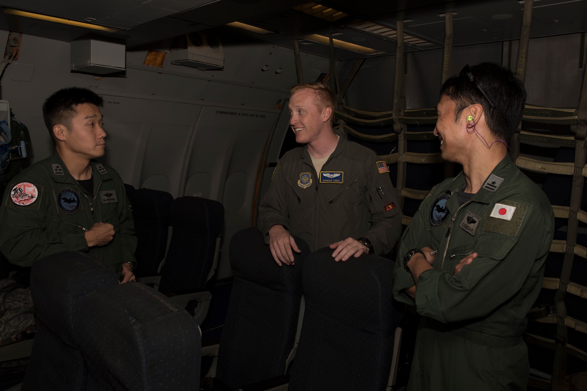 U.S. Air Force Capt. Spencer Turek (Center), 6th Air Refueling Squadron KC-10 Extender pilot, enjoys a conversation with two Japan Air Self-Defense Force pilots inside a KC-10 during a refueling mission in the Indo-Pacific theater June 4, 2018. During the mission, the KC-10 refueled six JASDF F-15 aircraft offloading nearly 130,000 pounds of fuel enabling the fighters to travel more than 2,900 nautical miles from Japan to Alaska. (U.S. Air Force photo by Tech. Sgt. James Hodgman)