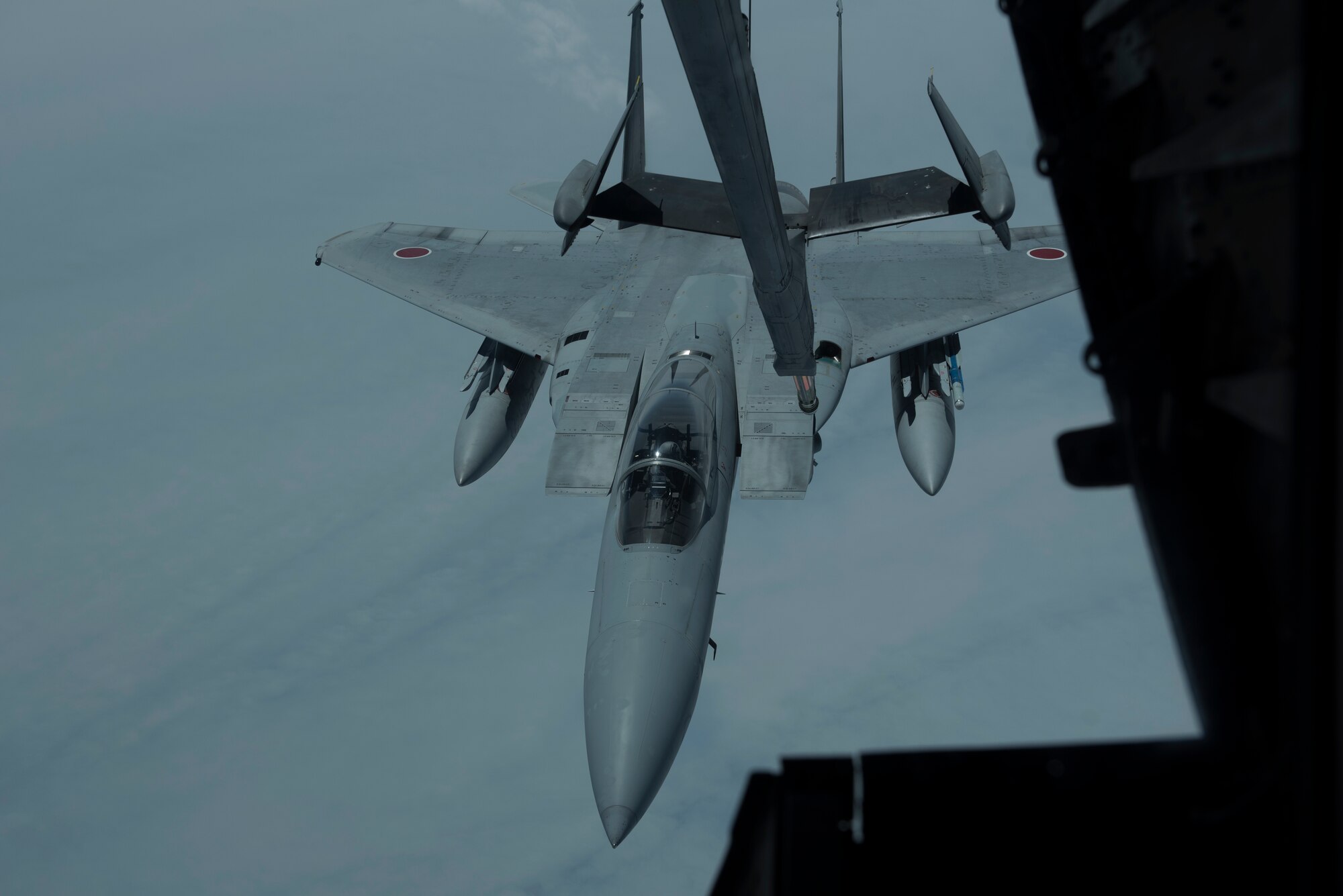 An F-15 is refueled by a U.S. Air Force KC-10 Extender from Travis Air Force Base, Calif., during a mission in the Indo-Pacific theater June 4, 2018. The KC-10 refueled six fighters from the Japan Air Self-Defense Force offloading more than 130,000 pounds of fuel enabling them to fly more than 2,900 nautical miles from Japan to Alaska. (U.S. Air Force photo by Tech. Sgt. James Hodgman)