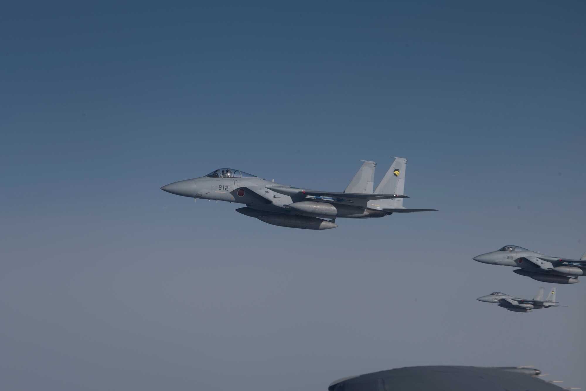 F-15s fly alongside a U.S. Air Force KC-10 Extender from Travis Air Force Base, Calif., during a refueling mission in the Indo-Pacific theater June 4, 2018. The KC-10 refueled six fighters from the Japan Air Self-Defense Force offloading more than 130,000 pounds of fuel enabling them to fly more than 2,900 nautical miles from Japan to Alaska. (U.S. Air Force photo by Tech. Sgt. James Hodgman)