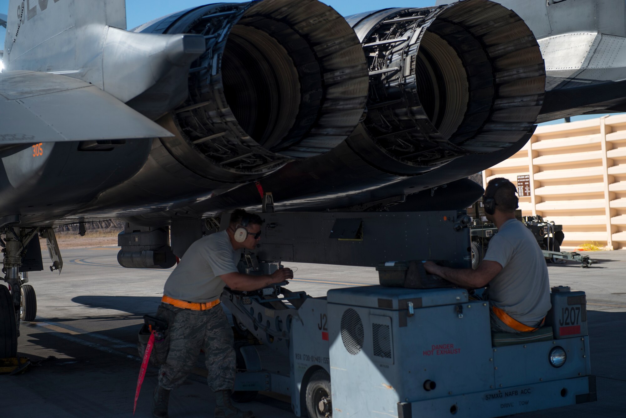 391st Fighter Squadron crew chiefs operate a jammer to remove a section of an F-15E Strike Eagle during Green Flag West, June 11, 2018, at Nellis Air Force Base, Nevada. The 391st FS participated in Green Flag to further enhance readiness by training on Close Air Support over the National Training Center, Fort Irwin, California. (U.S. Air Force photo by Airman 1st Class JaNae Capuno)