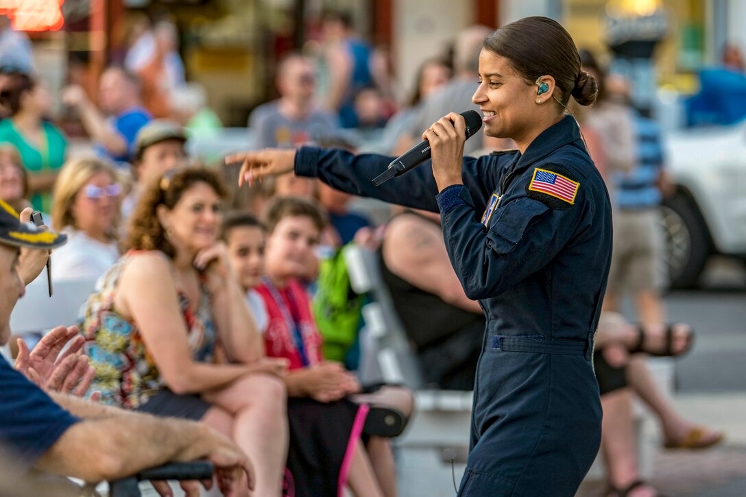 A singer performs in front of a group of people.