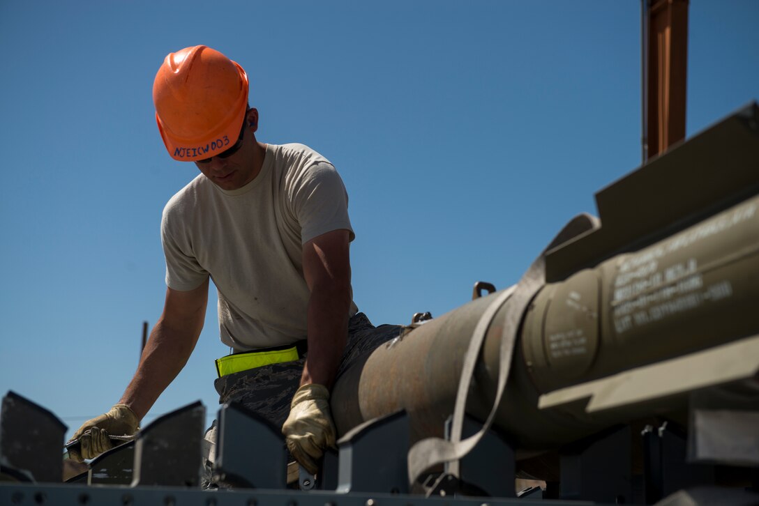 Senior Airman Daniel Jenkins, 366th Equipment Maintenance Squadron conventional crew member, straps a large conventional munition for transport during Green Flag West, June 11, 2018, at Nellis Air Force Base, Nevada.The 391st FS participated in Green Flag to further enhance readiness by training on Close Air Support over the National Training Center, Fort Irwin, California. (U.S. Air Force photo by Airman 1st Class JaNae Capuno)