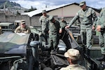 U.S. and Ecuadorean military members talk.