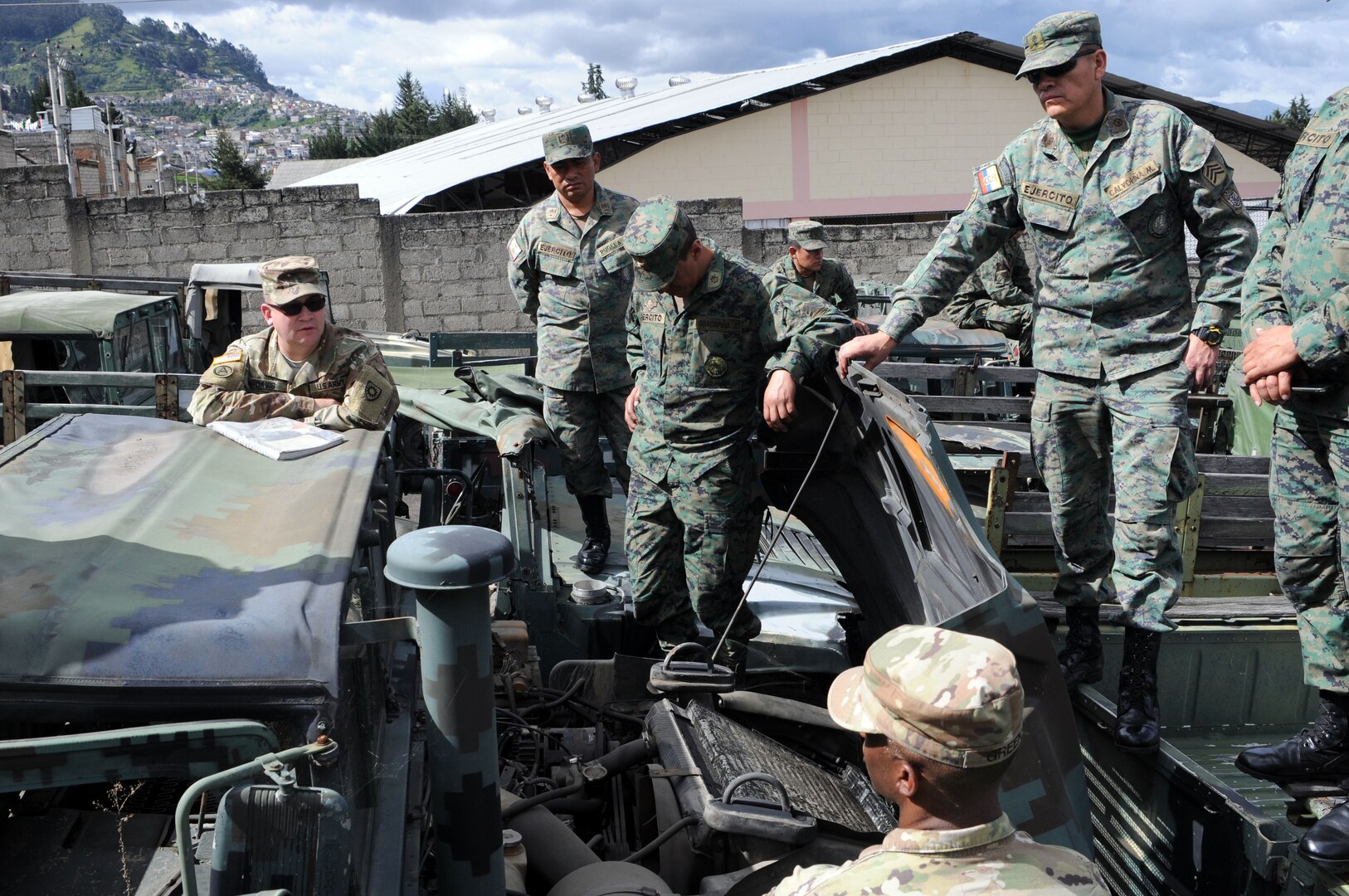 U.S. and Ecuadorean military members talk.