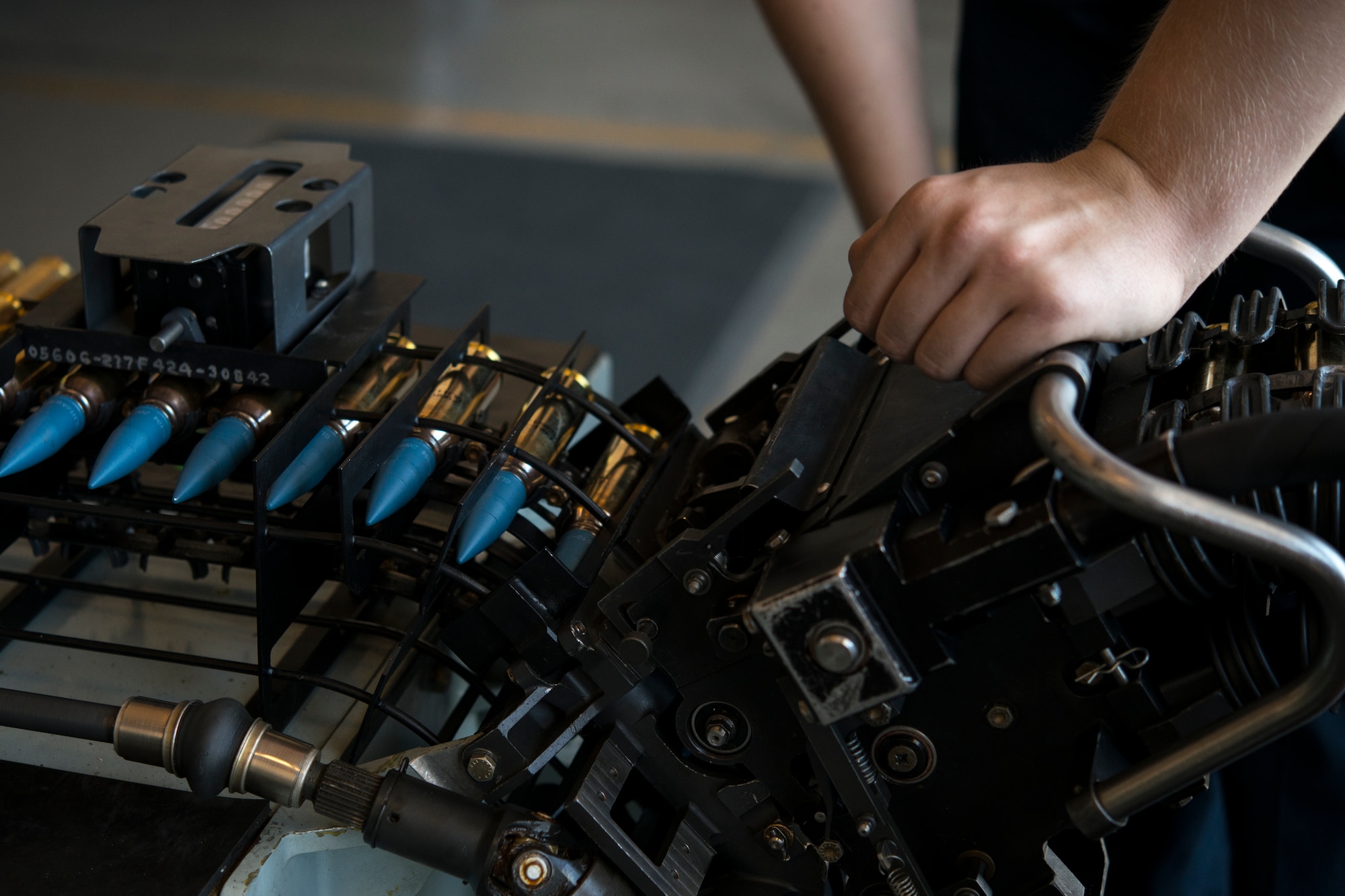 20 millimeter ammunition loads into a universal loading system during Green Flag West, June 11, 2018, at Nellis Air Force Base, Nevada. The 366th EMS augmented 57th EMS Airmen during Green Flag. This exercise enhanced readiness by providing Close Air Support training over the National Training Center, Fort Irwin, California. (U.S. Air Force photo by Airman 1st Class JaNae Capuno)
