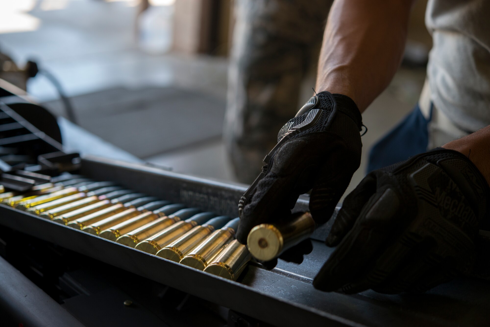 An Airman from the 57th Equipment Maintenance Squadron places a 20 millimeter ammunition into a universal loading system during Green Flag West, June 11, 2018, at Nellis Air Force Base, Nevada. The 366th EMS augmented 57th EMS Airmen during Green Flag. This exercise enhanced readiness by providing Close Air Support training over the National Training Center, Fort Irwin, California. (U.S. Air Force photo by Airman 1st Class JaNae Capuno)