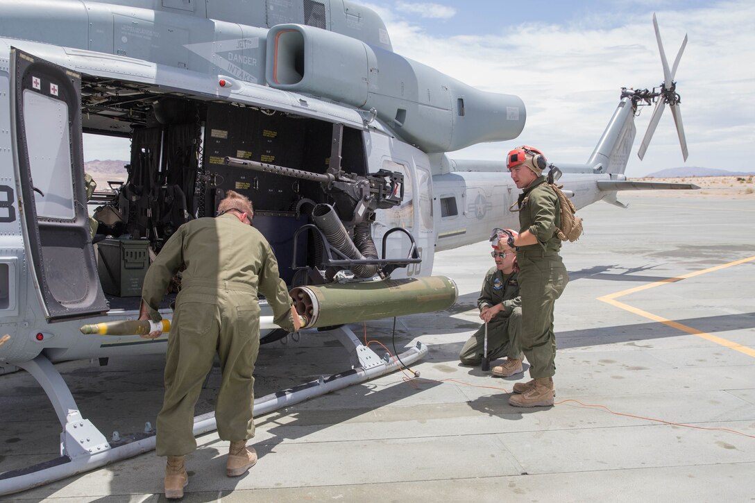 Marines with Marine Light Helicopter Attack Squadron 775, Marine Aircraft Group 41, 4th Marine Aircraft Wing, prepare 2.75 inch HE rockets into a UH-1Y Venom helicopter, during Integrated Training Exercise 4-18 at Marine Corps Air Ground Combat Center Twentynine Palms, Calif., June 15, 2018. ITX 4-18 provides Marine Air Ground Task Force elements an opportunity to undergo a service-level assessment of core competencies that are essential to expeditionary, forward-deployed operations. (U.S. Marine Corps photo by Lance Cpl. Samantha Schwoch/released)