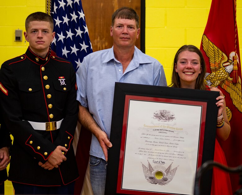 Hunter A. Northcutt’s father, Marty Northcutt, sister, Tori Northcutt, and cousin, Pfc. Gavin G. Northcutt, hold the Honorary Marine award (posthumously) for Hunter at Pelham Elementary School, Pelham, Tennessee, June 13, 2018. Hunter perished from acute leukemia on September 18, 2017 at just 15 years old. (U.S. Marine Corps photo by Sgt. Mandaline Castillo)