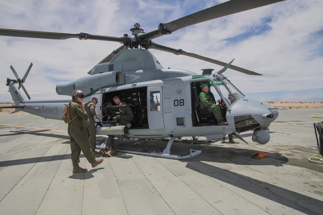 Marines with Marine Light Attack Helicopter Squadron 775, Marine Aircraft Group 41, 4th Marine Aircraft Wing, conduct pre-flight operations on a UH-1Y Venom during Integrated Training Exercise 4-18 at Marine Corps Air Ground Combat Center Twentynine Palms, Calif., June 15, 2018. ITX 4-18 provides Marine Air Ground Task Force elements an opportunity to undergo a service-level assessment of core competencies that are essential to expeditionary, forward-deployed operations. (U.S. Marine Corps photo by Lance Cpl. Samantha Schwoch/released)