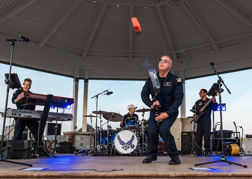 Senior Master Sgt. Ryan Carson, Max Impact superintendent and vocalist, launches a t-shirt into the audience June 16, 2018, at Rehoboth Beach, Del. Hundreds of beachgoers watched Max Impact perform for more than an hour during the Rehoboth Beach Bandstand Summer Concert Series. Max Impact, the premier rock band of the U.S. Air Force, is stationed at Joint Base Anacostia-Bolling in Washington, D.C. (U.S. Air Force photo by Roland Balik)
