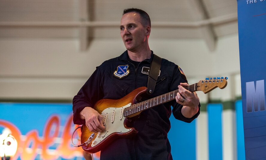 Senior Master Sgt. Matthew Ascione, Max Impact guitarist, plays the electric guitar June 16, 2018, on the bandstand at Rehoboth Beach, Del. Ascione has the additional duty as the section chief of Outreach and Media Relations for the organization. Max Impact, the premier rock band of the U.S. Air Force, is stationed at Joint Base Anacostia-Bolling in Washington, D.C. (U.S. Air Force photo by Roland Balik)