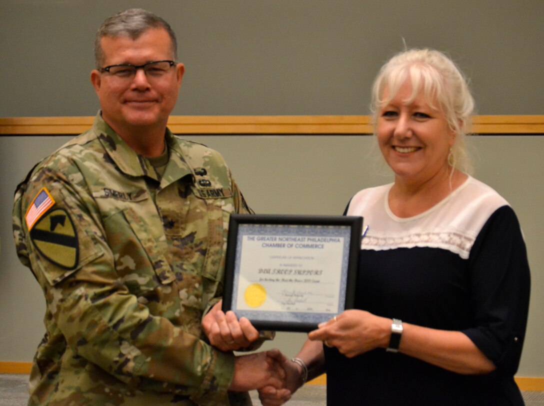 Defense Logistics Agency Troop Support Commander Army Brig. Gen. Mark Simerly (left) is presented a certificate of appreciation by Pam Henshall, president of the Greater Northeast Philadelphia Chamber of Commerce in Philadelphia on June 18.