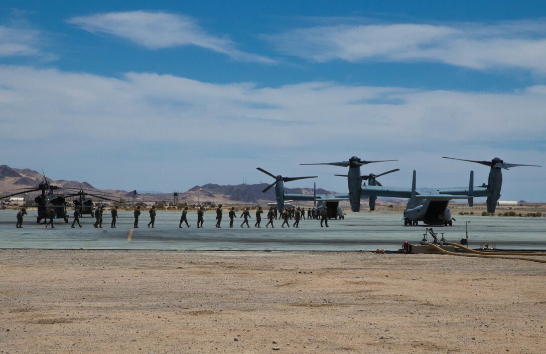 Marines participating in Integrated Training Exercise 4-18 make their way to MV-22 Ospreys with Marine Medium Tiltrotor Squadron 764, Marine Aircraft Group 41, 4th Marine Aircraft Wing, for a motivation flight, at Marine Corps Air Ground Combat Center Twentynine Palms, Calif., June 16, 2018. MAG 41, comprised of fixed wing tactical aircraft, tilt-rotor aircraft and rotary-wing assault support aircraft, provide the Aviation Combat Element to Marine Air-Ground Task Force 23 during ITX 4-18. (U.S. Marine Corps photo by Lance Cpl. Samantha Schwoch/released)