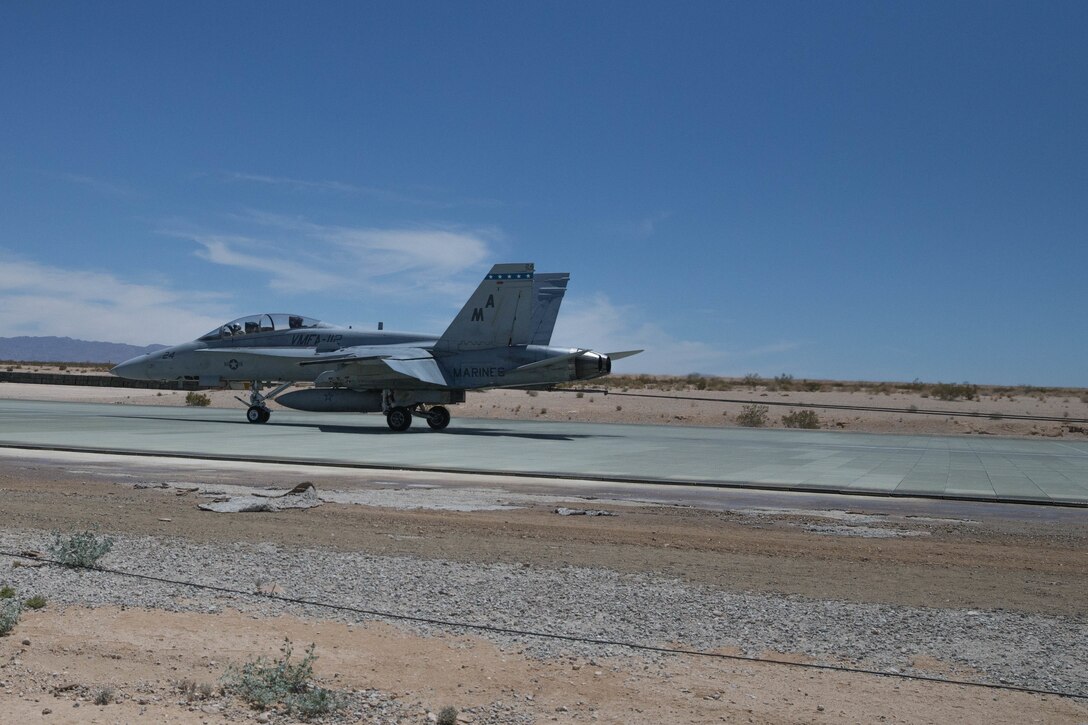 An F/A-18F with Marine Fighter Attack Squadron 112, Marine Aircraft Group 41, 4th Marine Aircraft Wing, conducts an arrested landing with Marine Wing Support Squadron 473, Marine Aircraft Group 41, 4th Marine Aircraft Wing, during Integrated Training Exercise 4-18 at Marine Corps Air Ground Combat Center Twentynine Palms, Calif., June 16, 2018. MAG 41, comprised of fixed wing tactical aircraft, tilt-rotor aircraft and rotary-wing assault support aircraft, provide the Aviation Combat Element to Marine Air-Ground Task Force 23 during ITX 4-18. (U.S. Marine Corps photo by Lance Cpl. Samantha Schwoch/released)