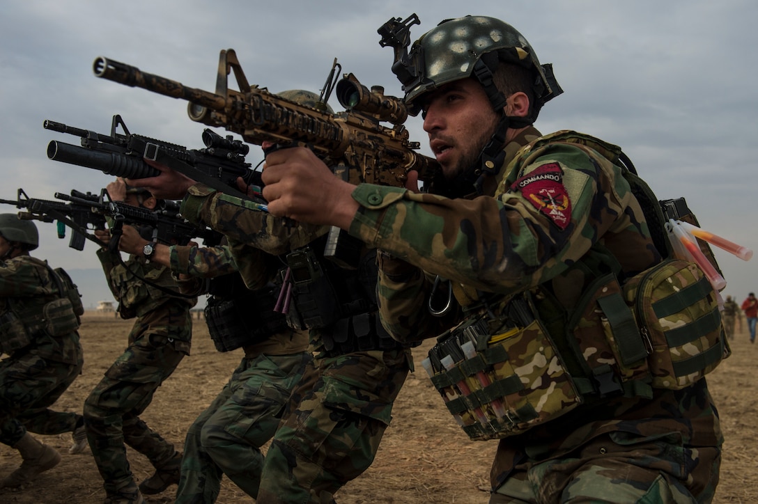 An Afghan National Army commando squad conducts live-fire exercises during training at Camp Pamir, Kunduz province, Afghanistan.