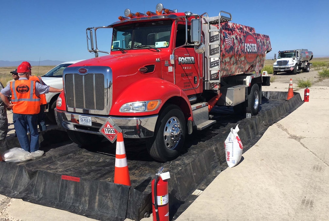 A fuel truck sits with its driver outside a readiness drill.