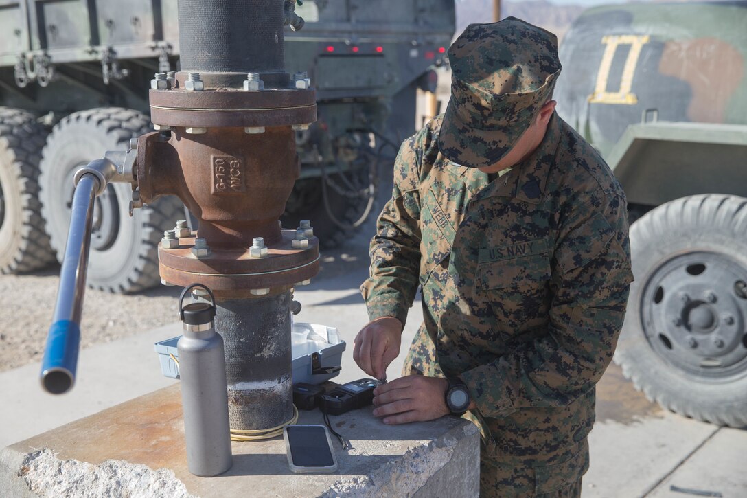 Seaman Kyler Webb, a hospital corpsman from the Naval Health Clinic, Corpus Christi, conducts tests on water from the water bowl to ensure it contains proper amounts of chlorine, during Integrated Training Exercise 4-18 in Marine Corps Air Ground Combat Center Twentynine Palms, Calif., June 17, 2018. MCAGCC Twentynine Palms has 28 water bowls placed throughout base and nine containers that are transportable for training during ITX 4-18. Each water bowl holds 400 gallons and each container can hold 900 gallons. (U.S. Marine Corps photo by Lance Cpl. Samantha Schwoch/released)